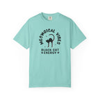 A light aqua blue short-sleeve t-shirt with a black graphic print on the front. The graphic features a black cat silhouette inside the text 'MEOWGICAL VIBES' arched above, and 'BLACK CAT ENERGY' with paw prints below.