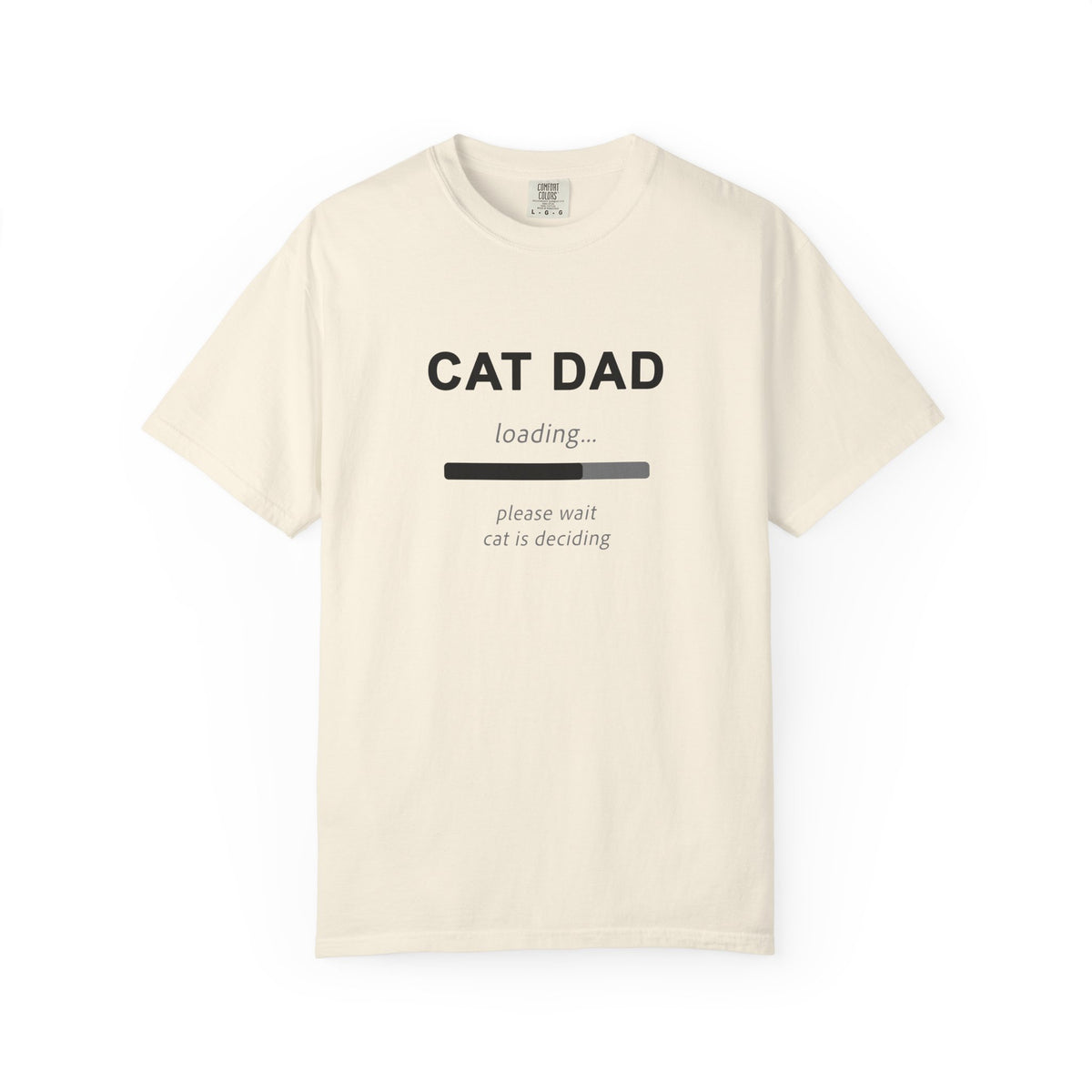 An off-white short-sleeve t-shirt with a black graphic print that reads 'CAT DAD' above a loading bar and the text 'please wait cat is deciding'.
