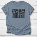 A slate blue crewneck t-shirt with a black graphic print that reads 'I PAY FOR BILLS MY CAT TAKES TREATS' styled like a barcode, laid flat on a white wood plank background.
