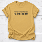 A mustard yellow short-sleeve t-shirt with the text 'I'M NOT IGNORING YOU. I'M WITH MY CAT.