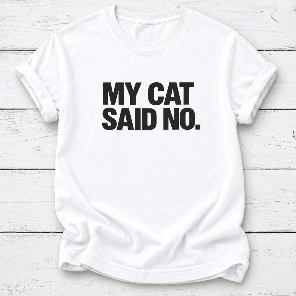 White T-shirt with bold black “My Cat Said No.” lettering and rolled sleeves, laid flat on white wooden boards.